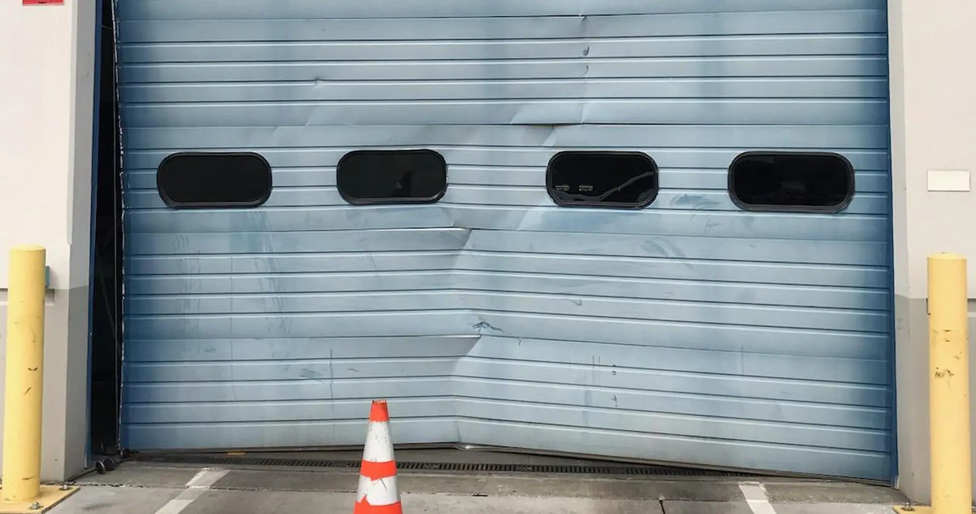 Loading dock sectional door crushed at the bottom