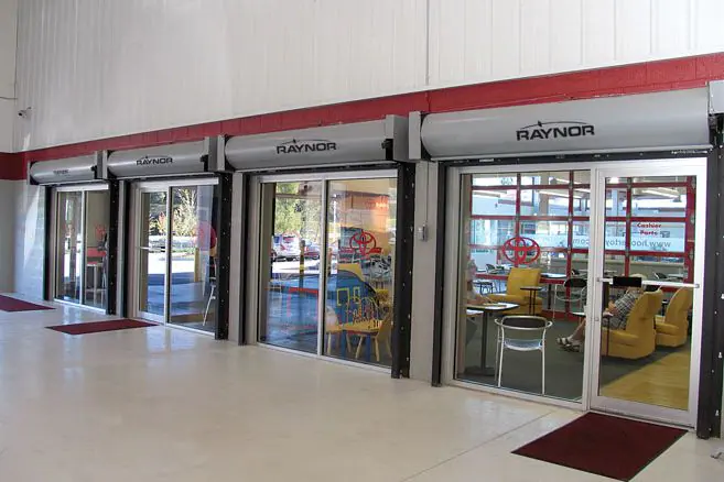 Fire-rated rolling doors above glass openings